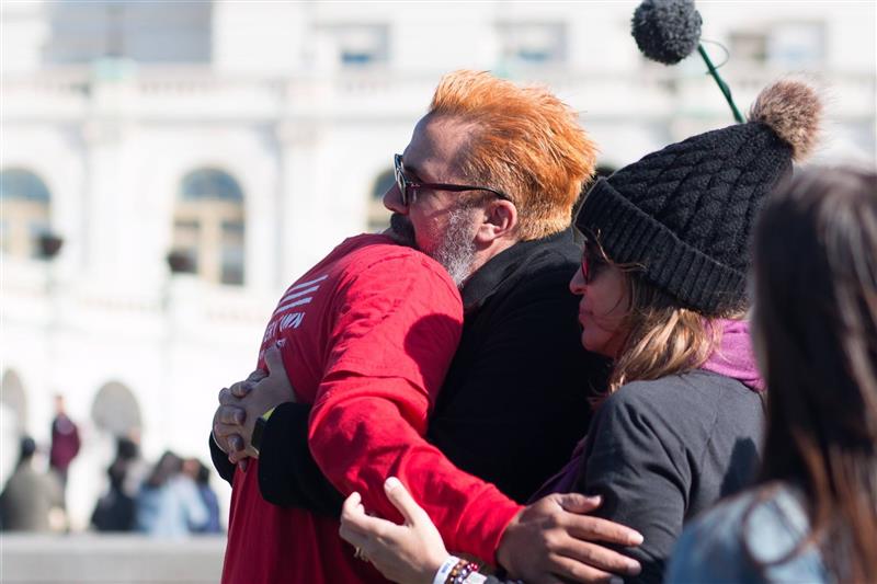 Khary Penebaker group hug at US Capitol rally