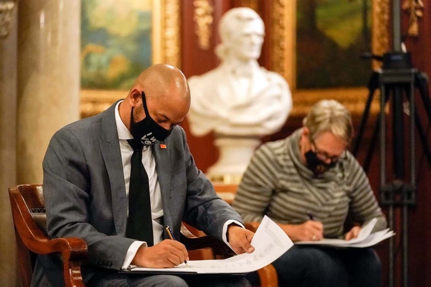 Khary Penebaker signing electoral documents as Biden Presidential Elector at the Wisconsin State Capitol in 2020