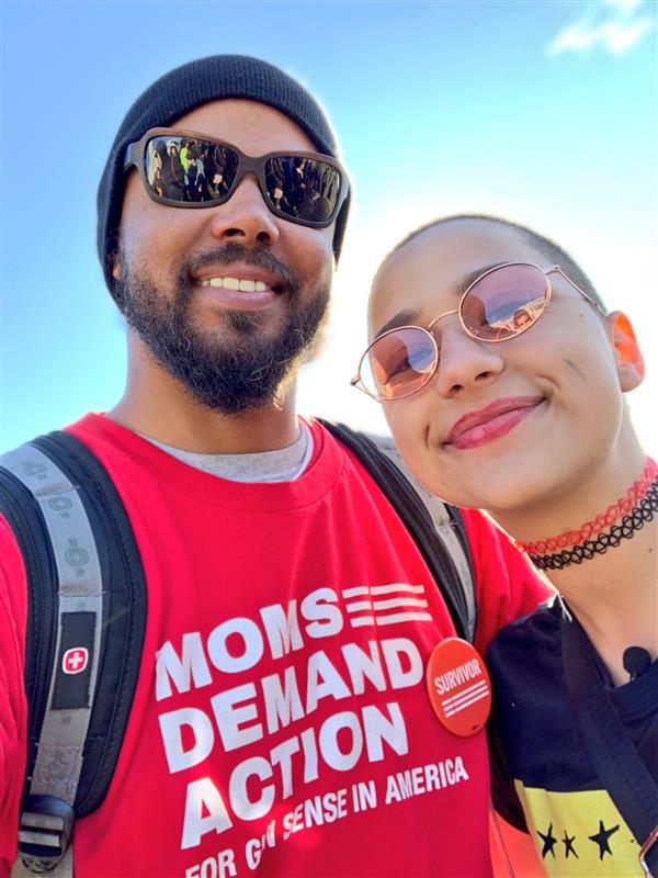 Khary Penebaker with fellow gun violence survivor at Moms Demand Action