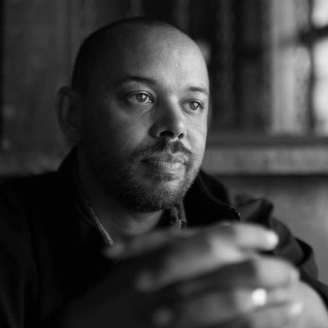 Black and white portrait of Khary Penebaker in a reflective moment