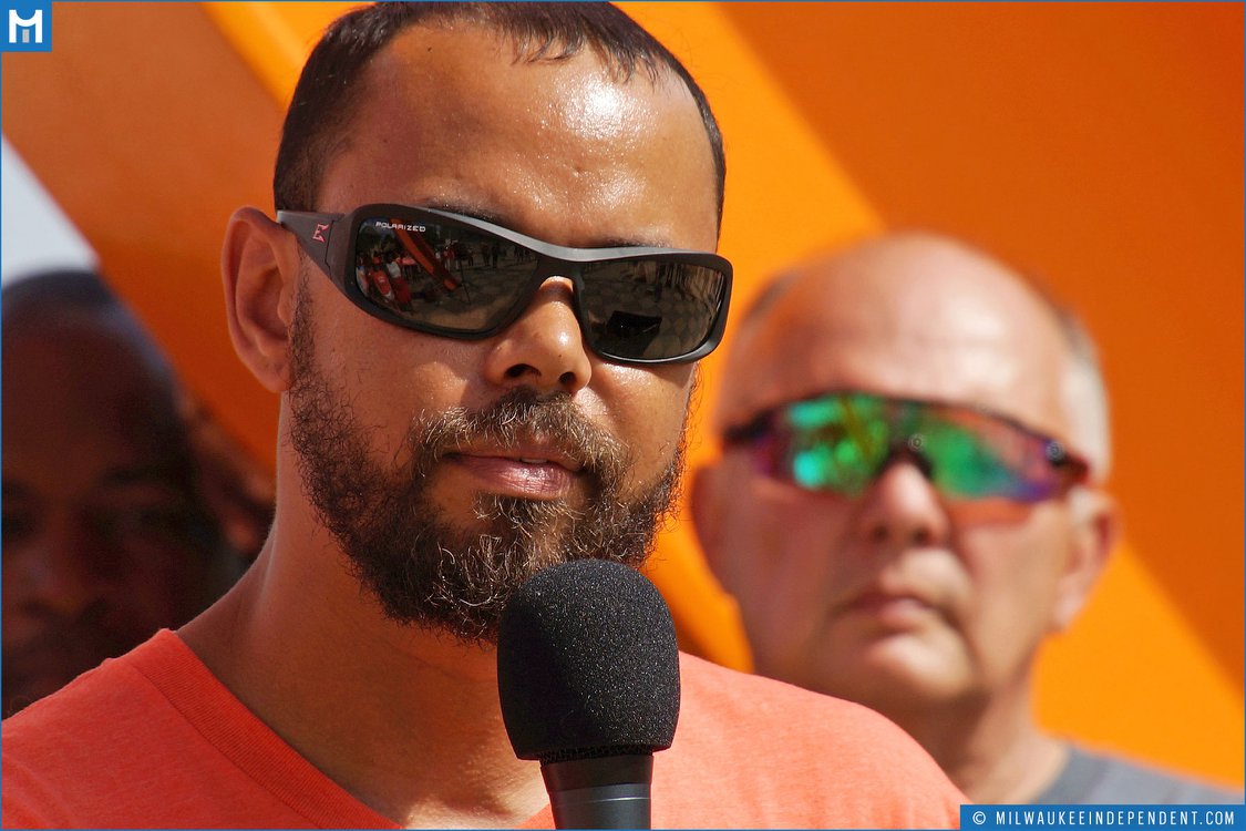 Khary Penebaker speaking with microphone, close-up