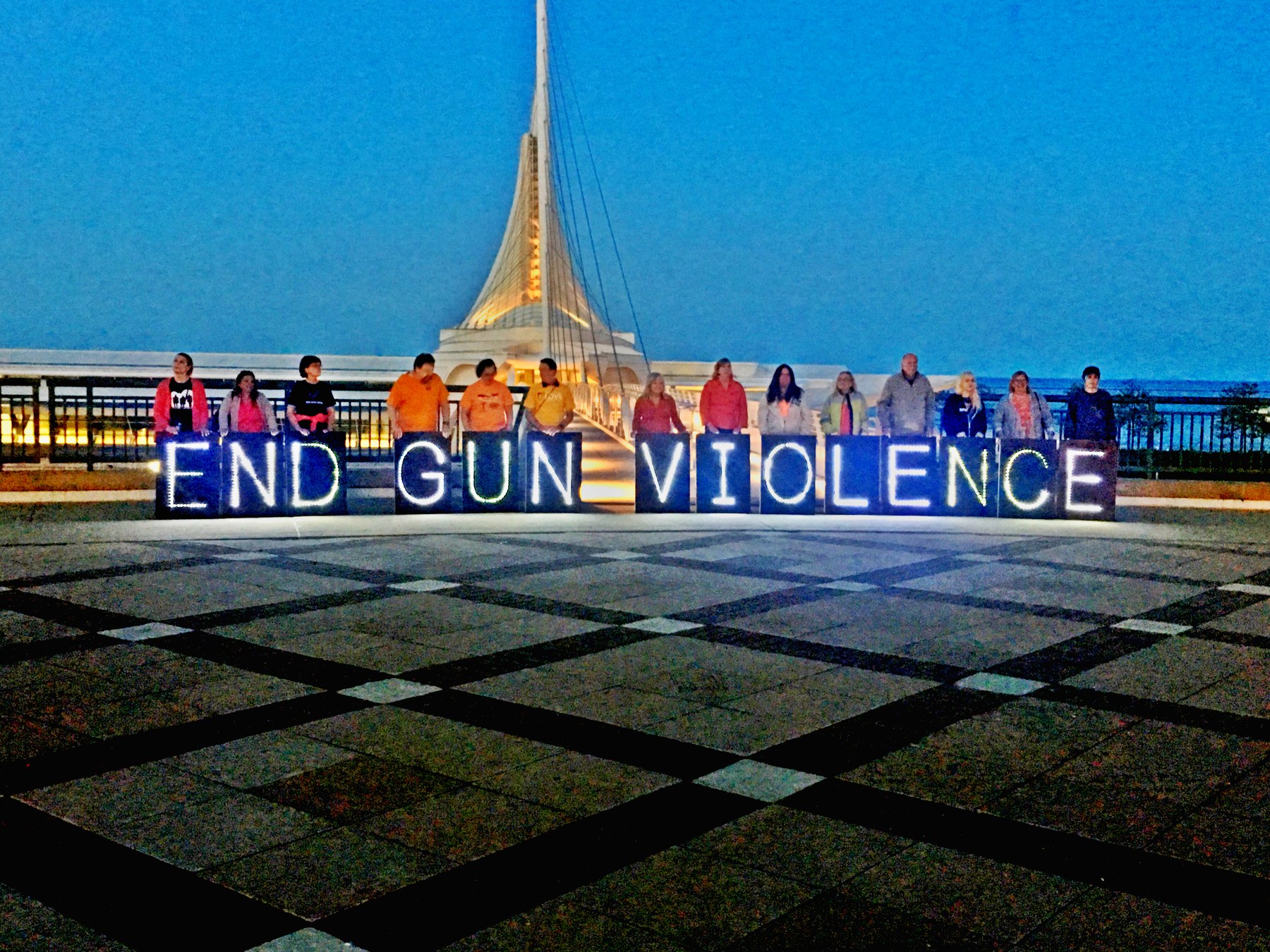 End Gun Violence vigil with lit letters spelling End Gun Violence in front of the Milwaukee Art Museum
