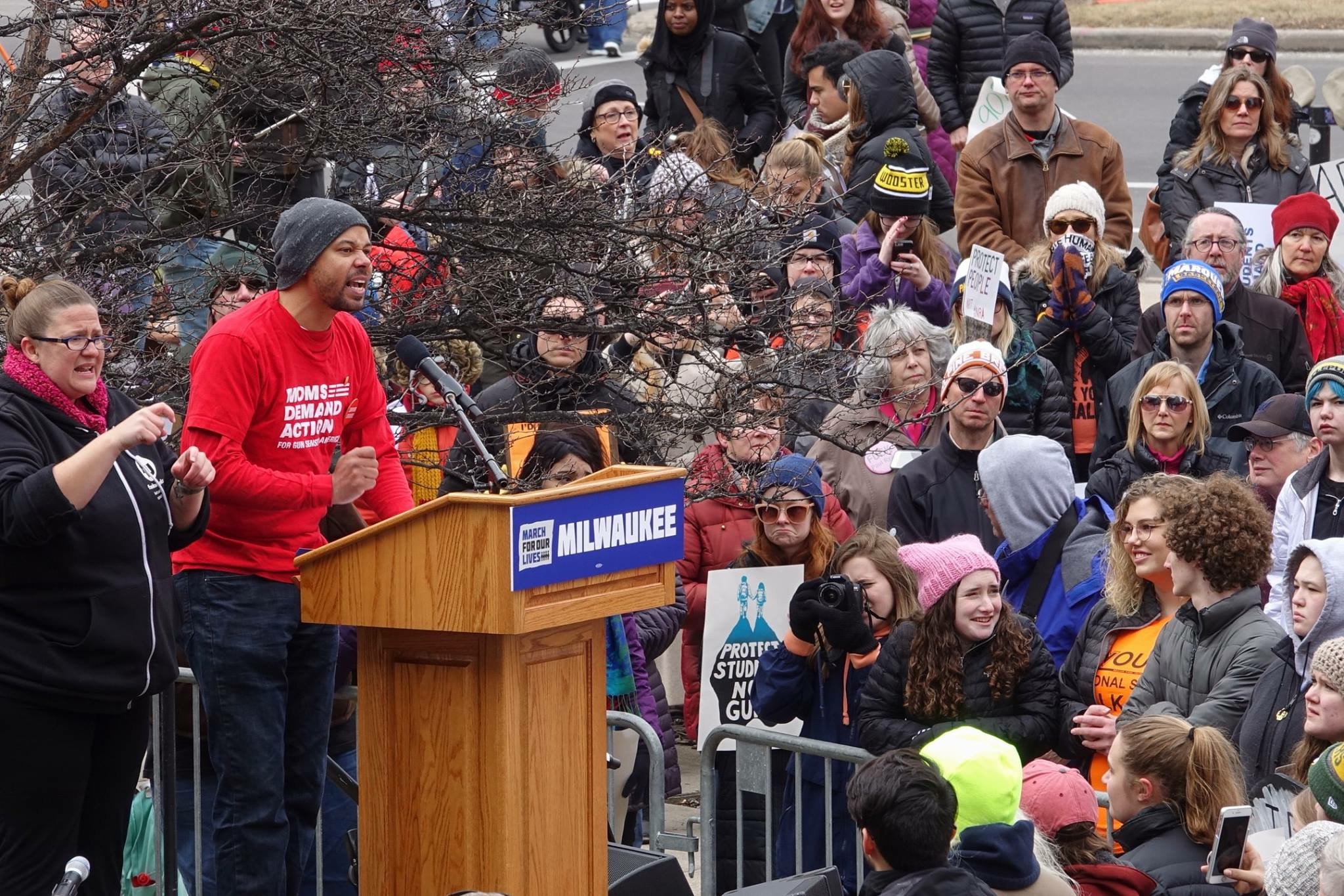 Khary Penebaker speaking at the March For Our Lives rally in Milwaukee, wearing a Moms Demand Action shirt