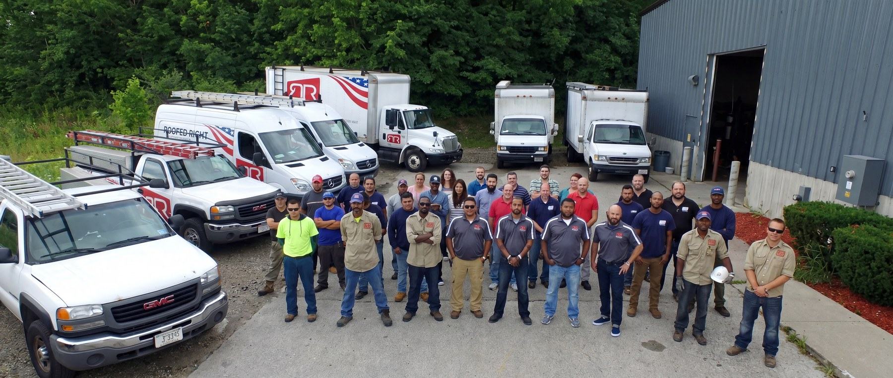 Roofed Right America team in front of company trucks